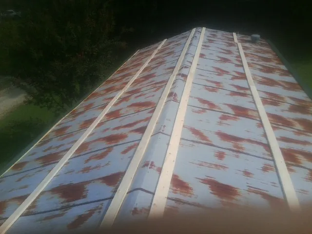 Rusted metal roof panels with new wood purlins before replacement — Storm Damage Roof Repair in Point Pleasant by Roofing Brothers