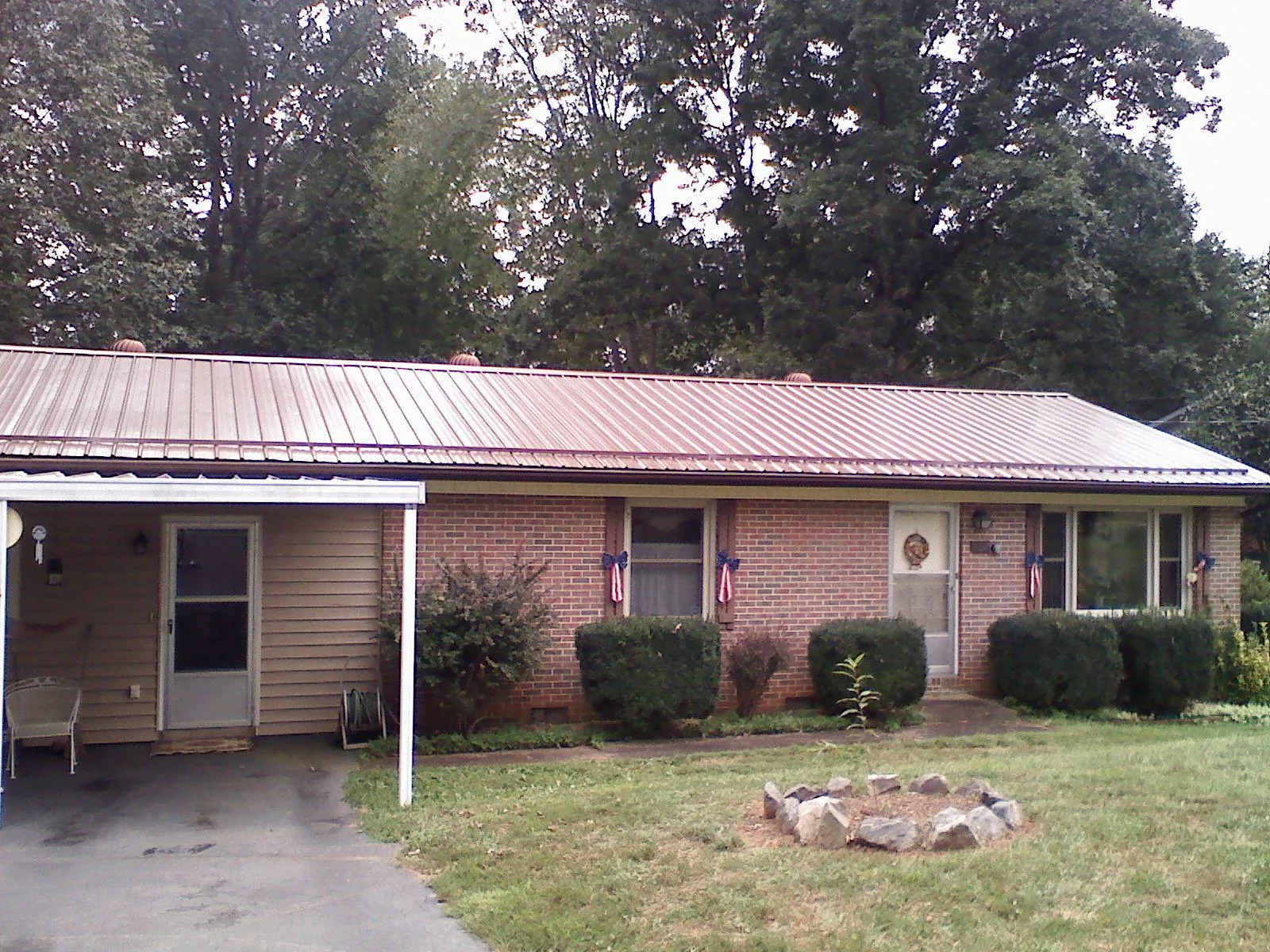 Bronze metal roof and carport on a brick ranch home — Roof Repair work by our crew in Point Pleasant