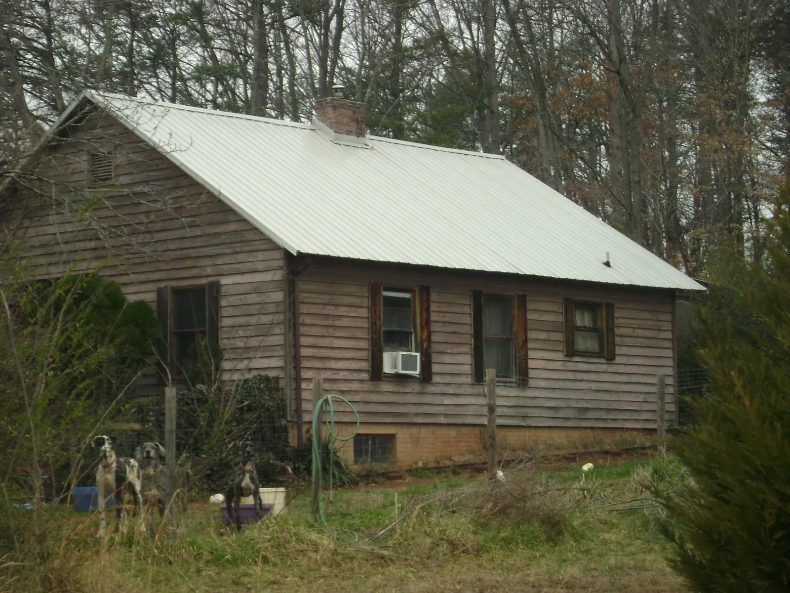 White metal roof on an old wood sided farmhouse, from a Metal Roof Installation job in Point Pleasant